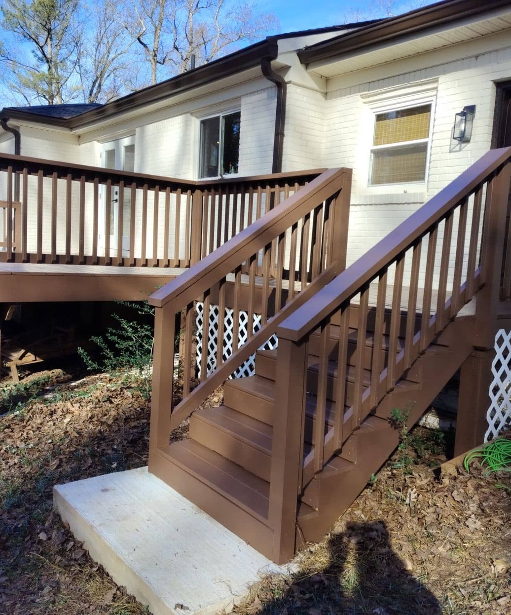 Freshly stained and restored deck with new railings and stairs