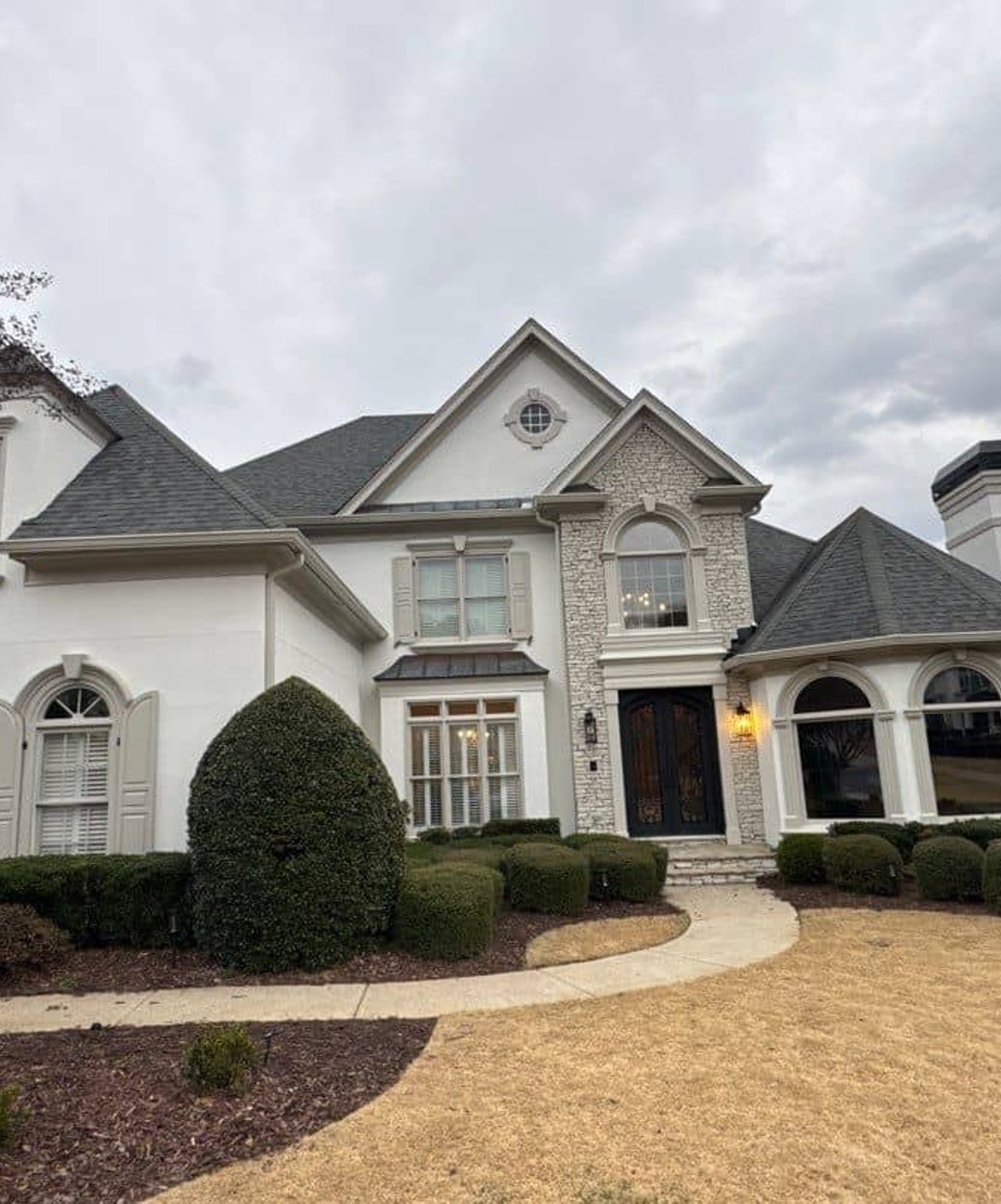 Limewashed home exterior with white stucco finish